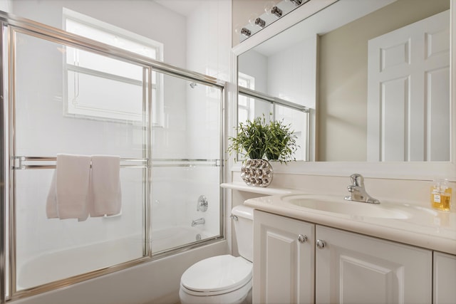 full bathroom featuring vanity, toilet, and enclosed tub / shower combo