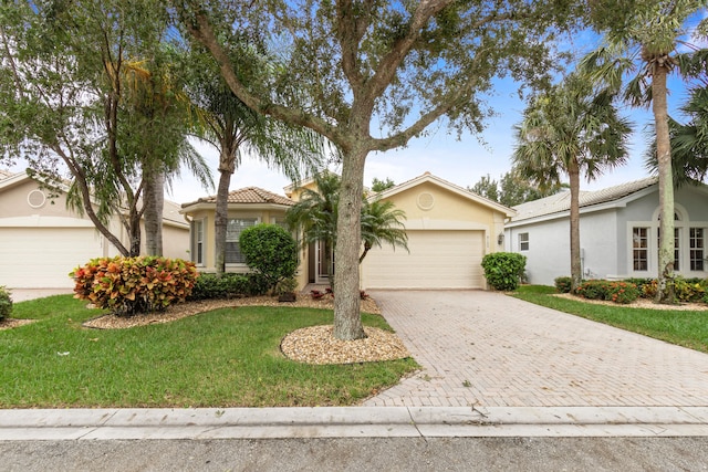 view of front of home with a front yard and a garage