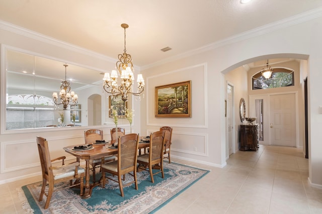 tiled dining room featuring ornamental molding, a healthy amount of sunlight, and an inviting chandelier