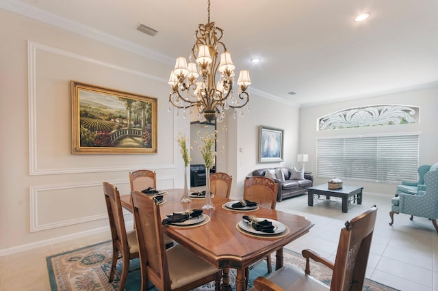 dining area with a chandelier, light tile patterned floors, and crown molding