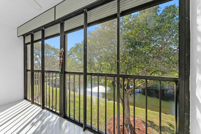 unfurnished sunroom with a water view and a healthy amount of sunlight