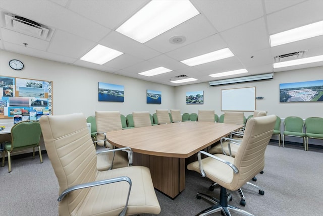 carpeted office space featuring a paneled ceiling