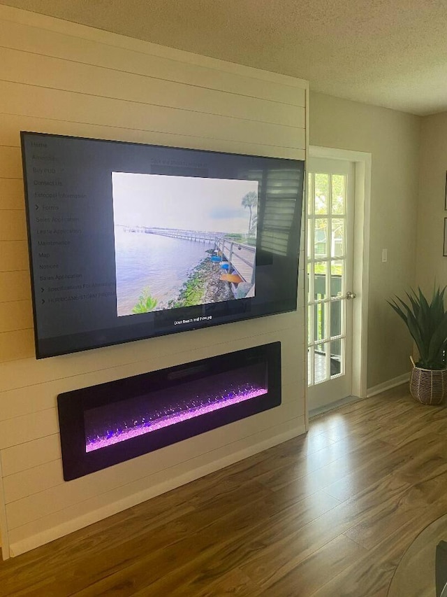 interior details with hardwood / wood-style floors and a textured ceiling