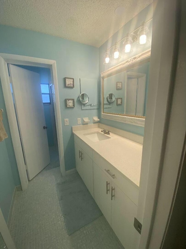 bathroom with vanity and a textured ceiling