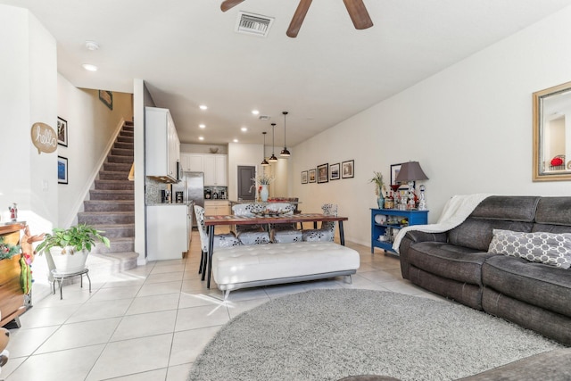 tiled living room with ceiling fan