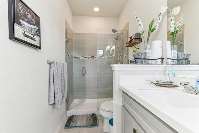 bathroom featuring vanity, toilet, tile patterned flooring, and walk in shower