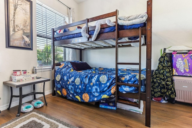 bedroom with multiple windows and hardwood / wood-style flooring