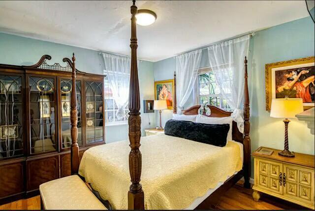 bedroom with dark wood-type flooring