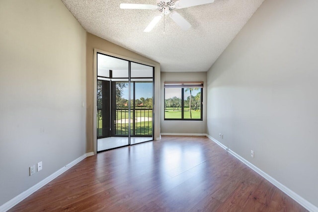 empty room with hardwood / wood-style flooring, ceiling fan, and a textured ceiling