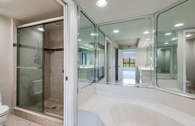 bathroom featuring toilet and shower with separate bathtub