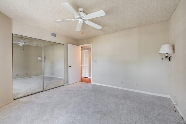 unfurnished bedroom with ceiling fan, a closet, and a textured ceiling