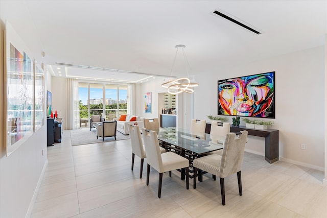 tiled dining room with expansive windows and a chandelier