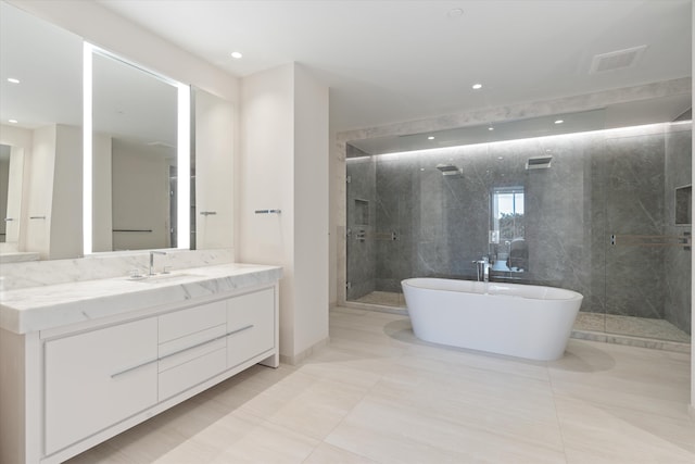 bathroom with vanity, tile patterned floors, and plus walk in shower