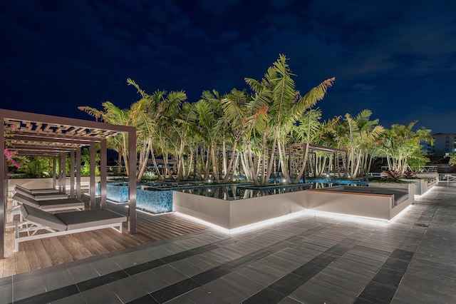 pool at night with a pergola