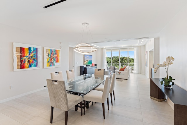 dining area with a wall of windows, a chandelier, and light tile patterned floors