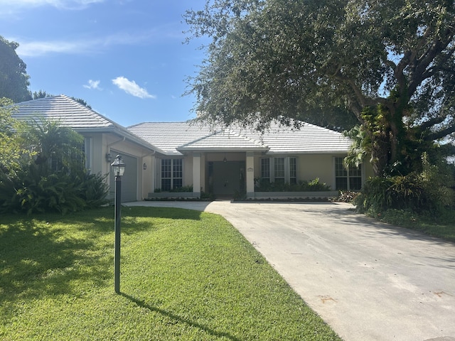 ranch-style house with a garage and a front yard