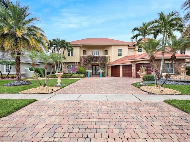 mediterranean / spanish home featuring a garage