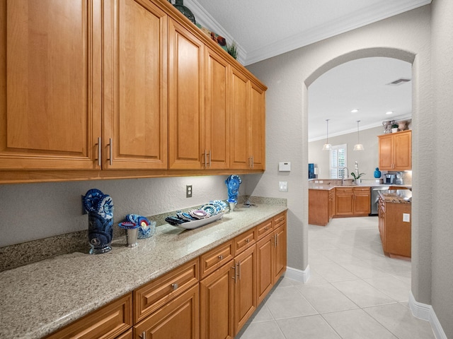 kitchen with stainless steel dishwasher, light tile patterned flooring, light stone countertops, and ornamental molding