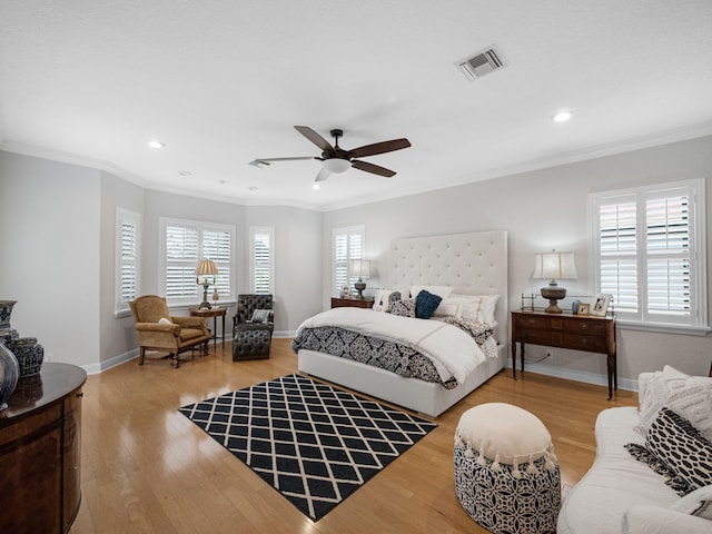 bedroom featuring multiple windows, ceiling fan, and crown molding