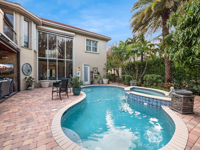 view of swimming pool with an in ground hot tub and a patio area