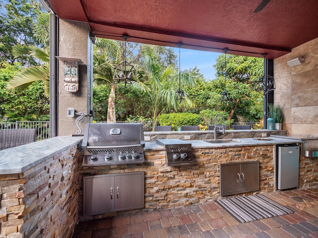 view of patio / terrace featuring exterior kitchen, sink, and grilling area