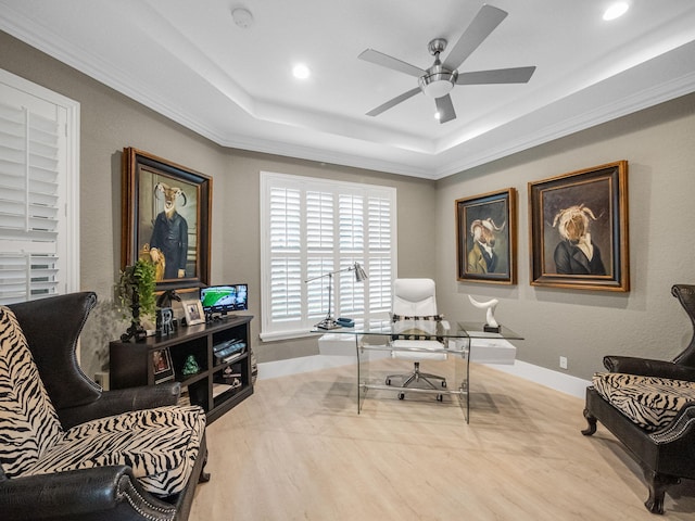 office area featuring wood-type flooring, a tray ceiling, ceiling fan, and crown molding