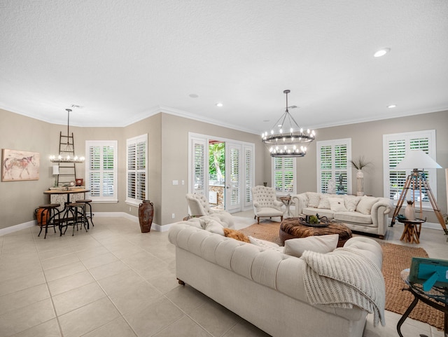 living room with a notable chandelier, light tile patterned floors, and crown molding