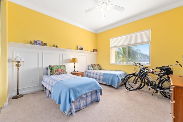 bedroom with light colored carpet, ceiling fan, and ornamental molding