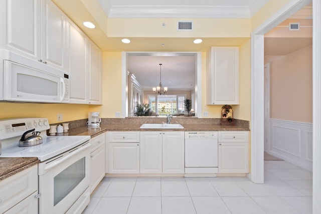 kitchen with white appliances, crown molding, sink, a notable chandelier, and white cabinetry