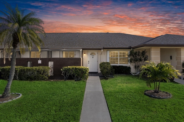 single story home featuring a yard