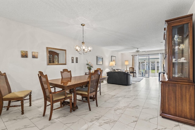 dining space with ceiling fan with notable chandelier and a textured ceiling