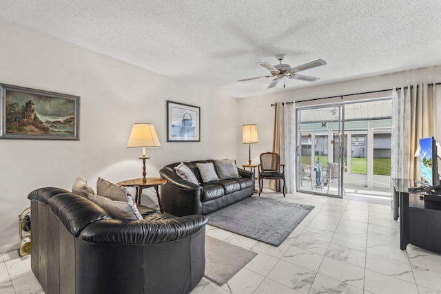 living room featuring a textured ceiling and ceiling fan