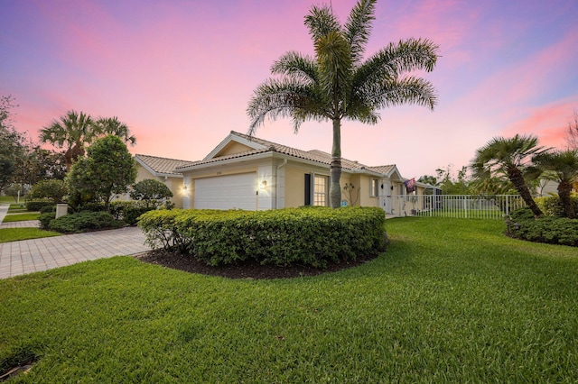 property exterior at dusk featuring a lawn and a garage