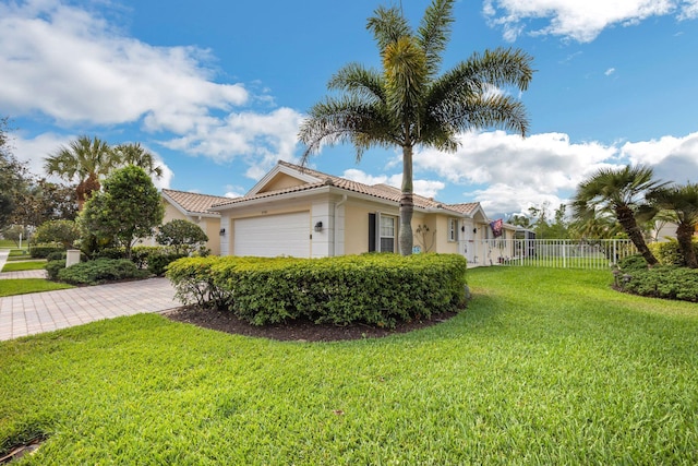 view of property exterior with a garage and a lawn