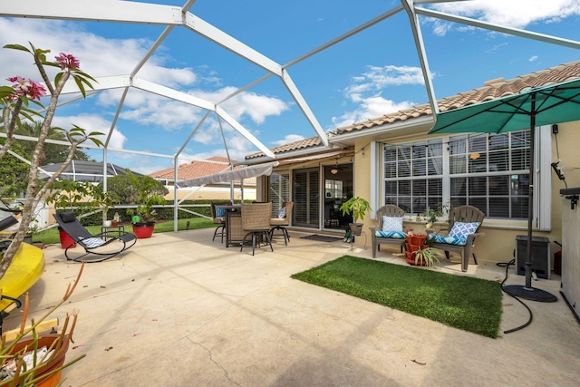 view of patio featuring glass enclosure