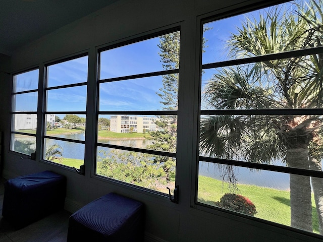 sunroom with plenty of natural light and a water view