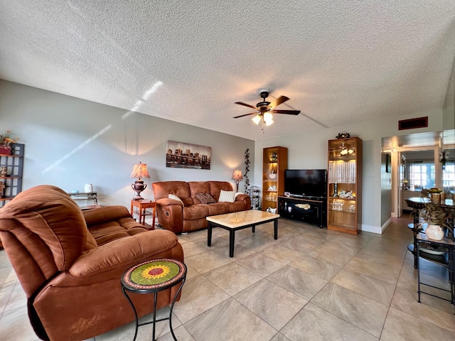 living room featuring a textured ceiling and ceiling fan