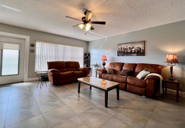 living room with ceiling fan and a textured ceiling