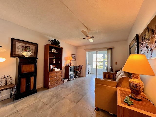 tiled living room with a textured ceiling and ceiling fan