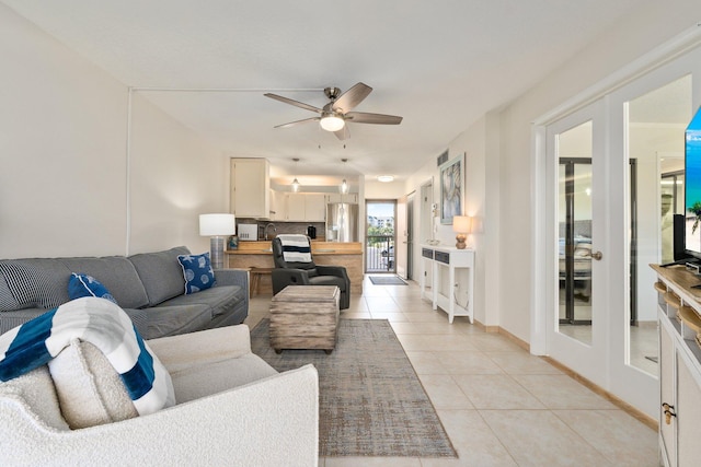 living room with ceiling fan, light tile patterned floors, and french doors