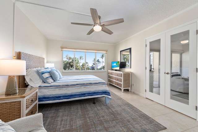 bedroom featuring ceiling fan, french doors, light tile patterned floors, and a textured ceiling