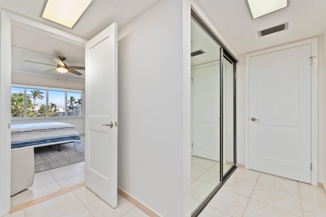 corridor featuring light tile patterned floors