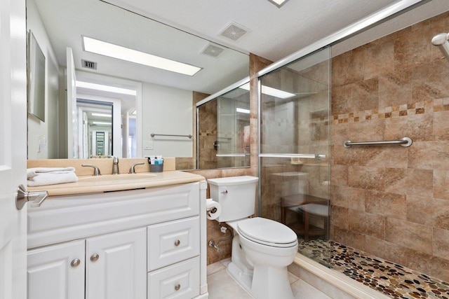 bathroom with tile patterned flooring, vanity, toilet, and an enclosed shower