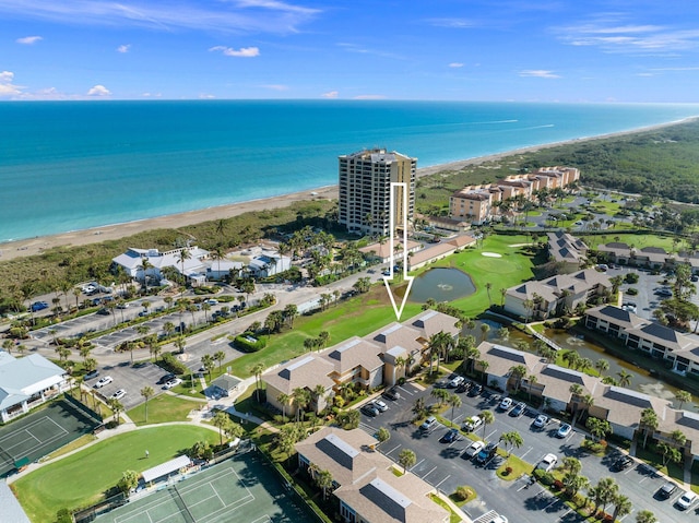 drone / aerial view with a water view and a beach view