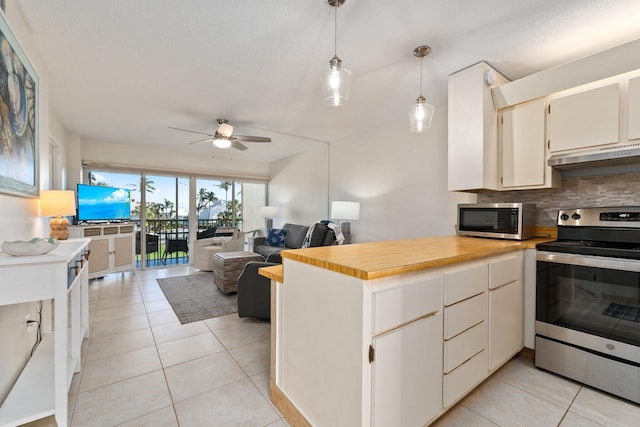 kitchen featuring stainless steel appliances, ceiling fan, exhaust hood, light tile patterned floors, and decorative light fixtures