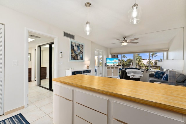 kitchen featuring a wealth of natural light, ceiling fan, and pendant lighting