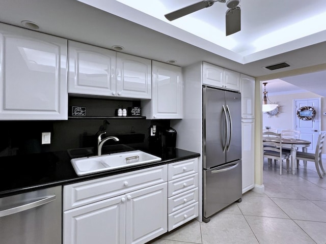 kitchen featuring white cabinets, sink, ceiling fan, light tile patterned flooring, and stainless steel appliances