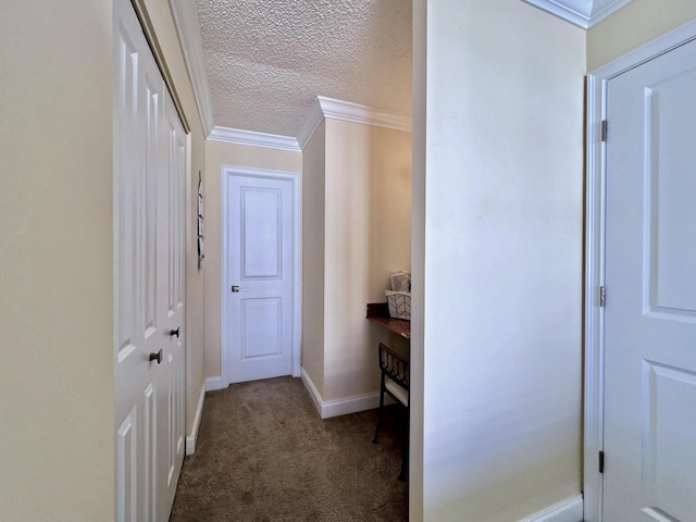 hall with carpet, crown molding, and a textured ceiling