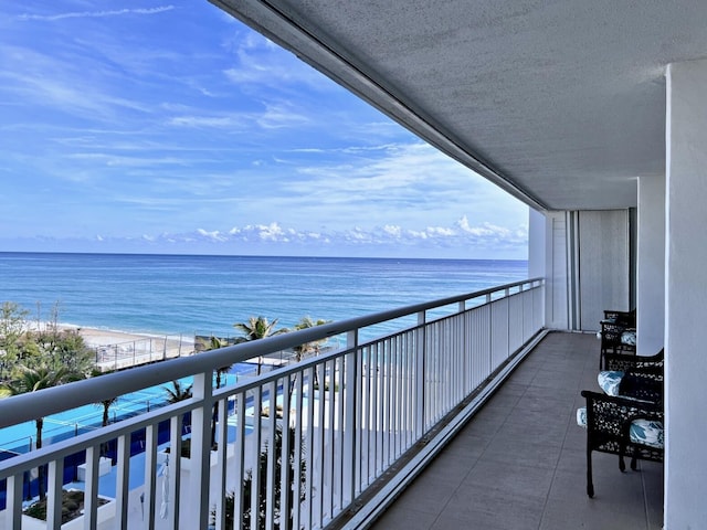 balcony with a view of the beach and a water view