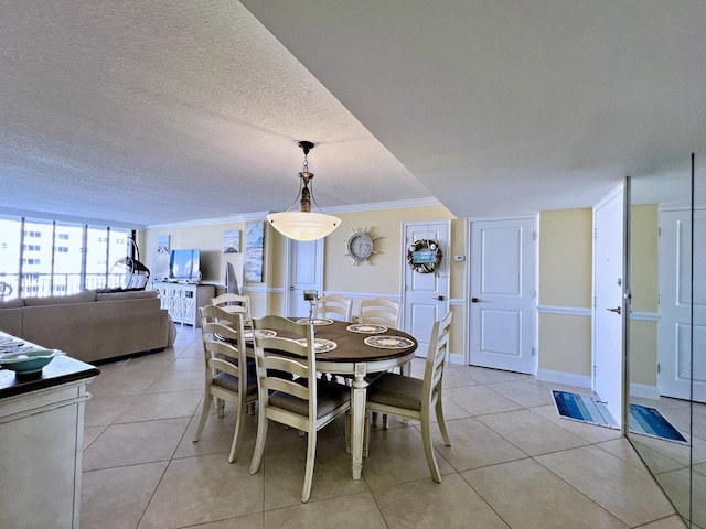 dining space featuring light tile patterned floors, a textured ceiling, and ornamental molding